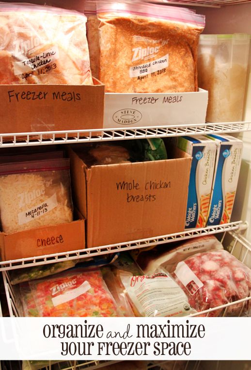 an open refrigerator filled with freezer meals and packaged food in boxes on the shelves