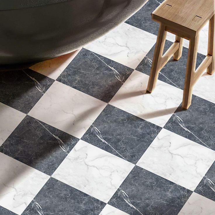 a black and white checkered tile floor with a wooden stool next to it in front of a bathtub