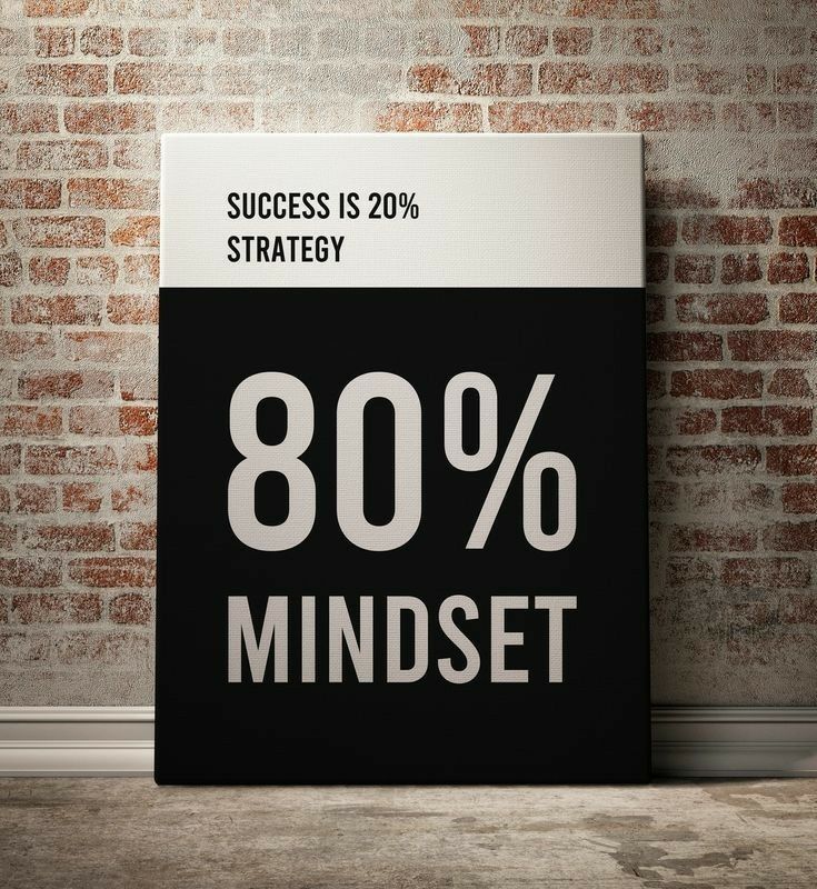 a black and white sign that says 80 % mindset in front of a brick wall