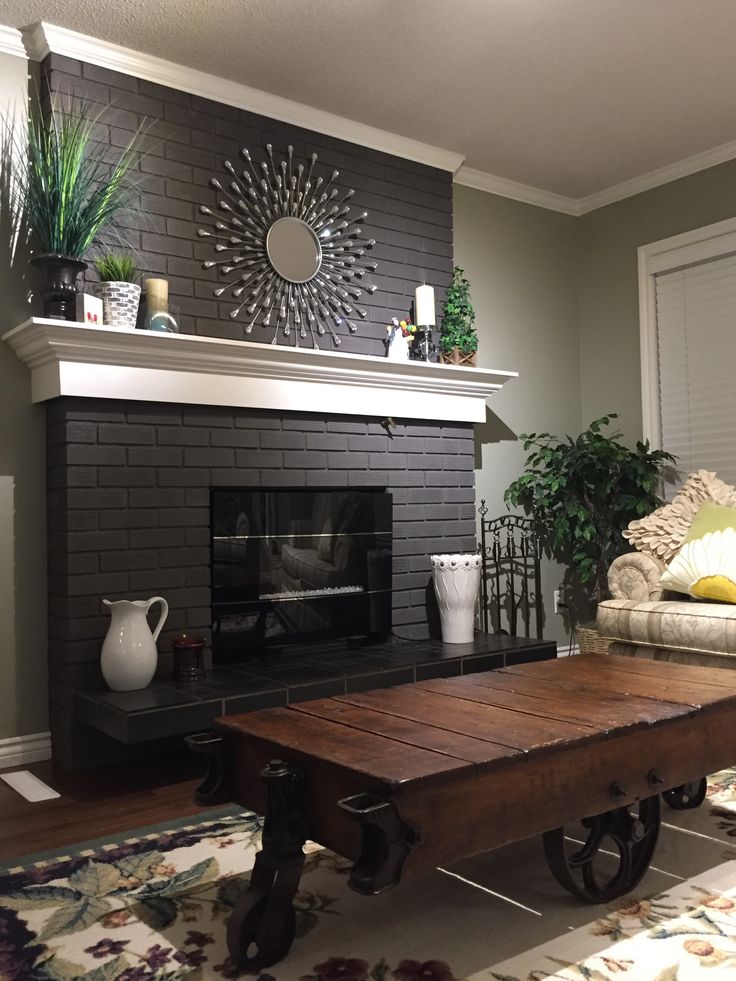 a living room with a couch, coffee table and fireplace