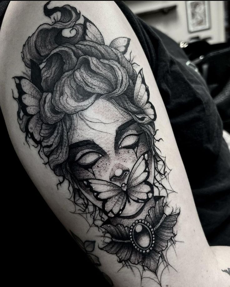 a woman's face and butterfly tattoo on the arm