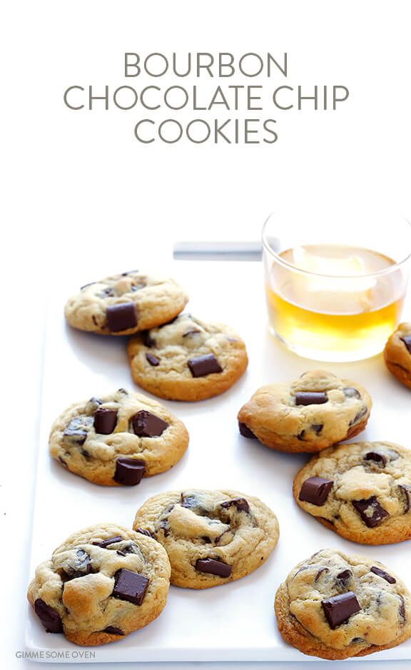 chocolate chip cookies on a white tray next to a glass of tea