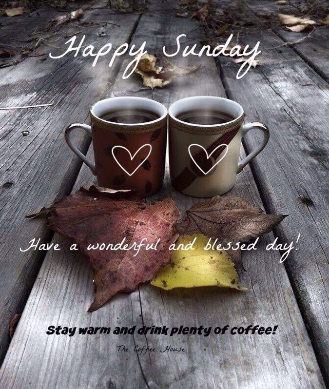 two coffee mugs sitting on top of a wooden table with autumn leaves and the words happy sunday have a wonderful and cherished day