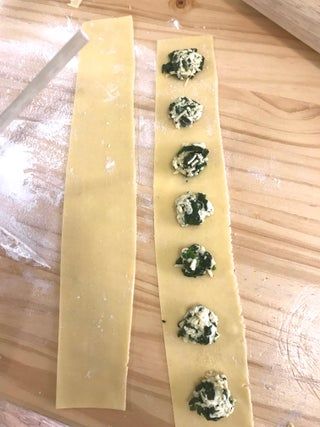 some food is sitting on top of a table next to a pair of knifes