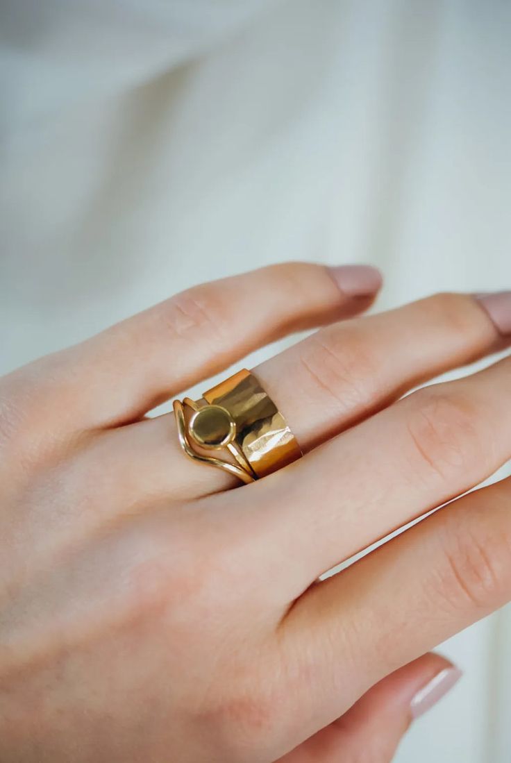 A large gold pebble sits on top of a delicate gold stacking ring. The band measures approximately 1mm in width. This ring is made entirely out of SOLID 14K GOLD metal. We make each 14K Gold pebble by hand so that each ring will look slightly unique — just like pebbles found in nature. We lightly hammered the band for a bright, reflective shine. Every piece is organic and unique — no two Hannah Naomi pieces are exactly alike.Hand-crafted to order in our Portland, OR studio. Hand Forged Modern Everyday Ring, Modern Hand Forged Everyday Ring, 14k Gold Moonstone Open Ring, Minimalist Hand Forged Open Band Ring, Modern Rings In Recycled Gold, Tarnish Resistant, Modern Recycled Gold Rings Tarnish Resistant, Stackable Open Rings In Recycled Gold With Polished Finish, Stackable Open Ring In Polished Recycled Gold, Polished Finish Recycled Gold Open Stackable Rings