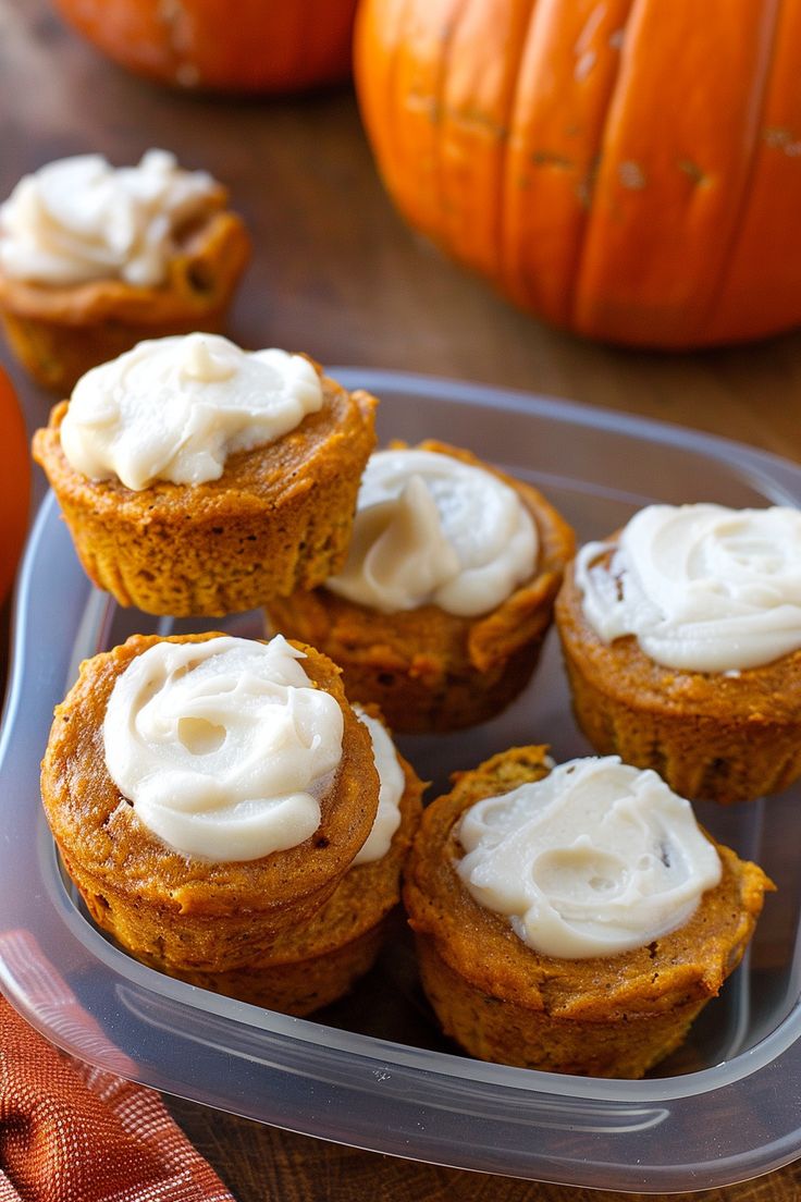 pumpkin cupcakes with cream cheese frosting on a plate