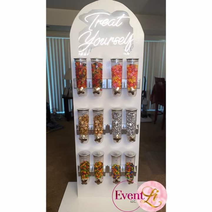 a display with jars filled with candy and candies next to a sign that says treat yourself