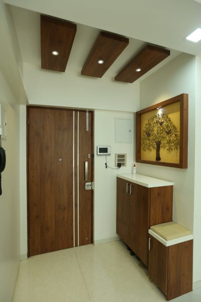 a bathroom with wooden cabinets and white walls