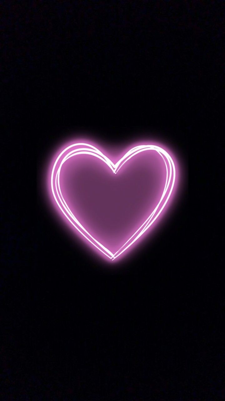 a heart shaped neon sign in the dark