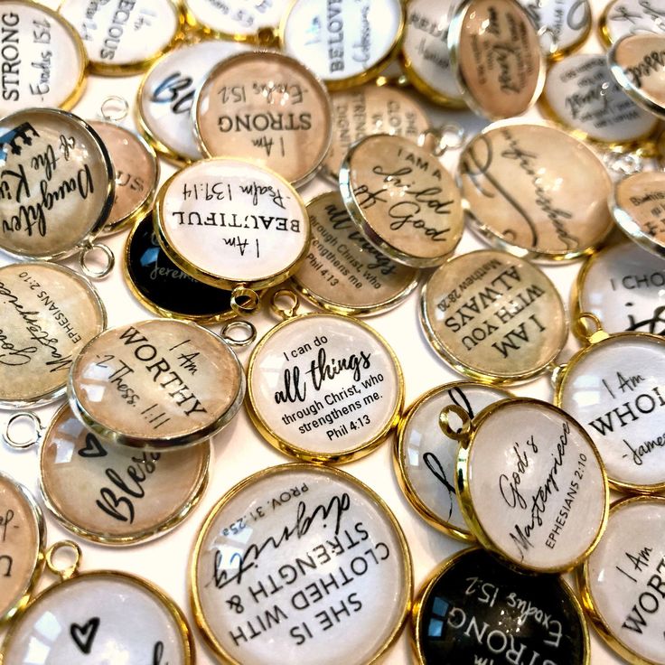 many different types of buttons with writing on them, all in gold and black colors