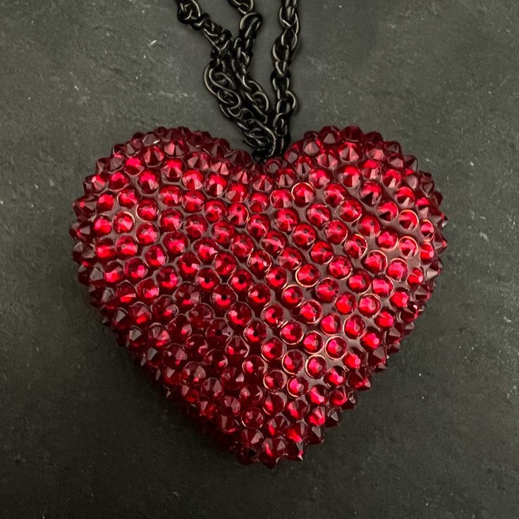 Handcrafted with care in Cleveland, this mini heart pendant is encrusted with 200+ sparkling crystals applied by hand, creating a dazzling and luxurious accessory. The miniature size makes it perfect for layering or wearing on its own, adding a touch of glamour to any outfit. DETAILS Heart Pendant: Classic 2" wide | Mini 1.5” wide Chain: 16" chain + 2" extender SIZE CHART Valentine's Day Party Crystal Heart Necklace, Crystal Heart Pendant Necklace For Party, Luxury Heart-shaped Jewelry For Party, Elegant Heart Necklace With Rhinestones For Parties, Glamorous Heart Pendant Jewelry For Party, Glamorous Crystal Necklace For Valentine's Day, Heart-shaped Party Jewelry, Heart-shaped Rhinestone Formal Jewelry, Heart Pendant Bling Jewelry For Party