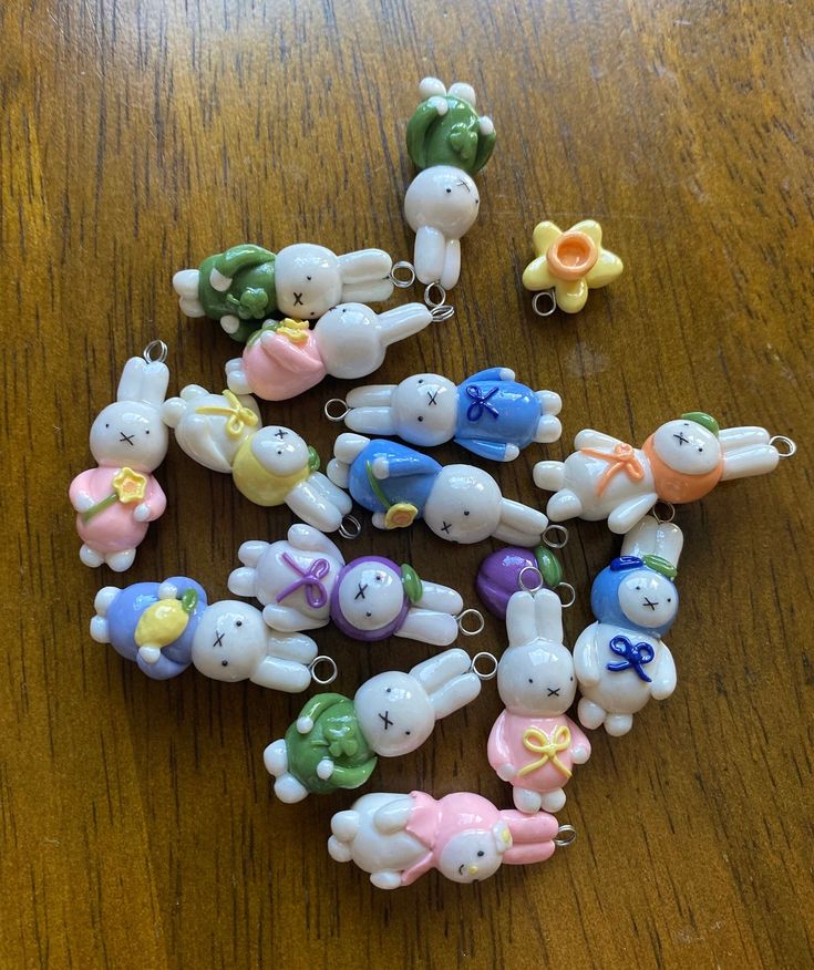 several small plastic toy animals on a wooden table with clippers in the shape of bunnies