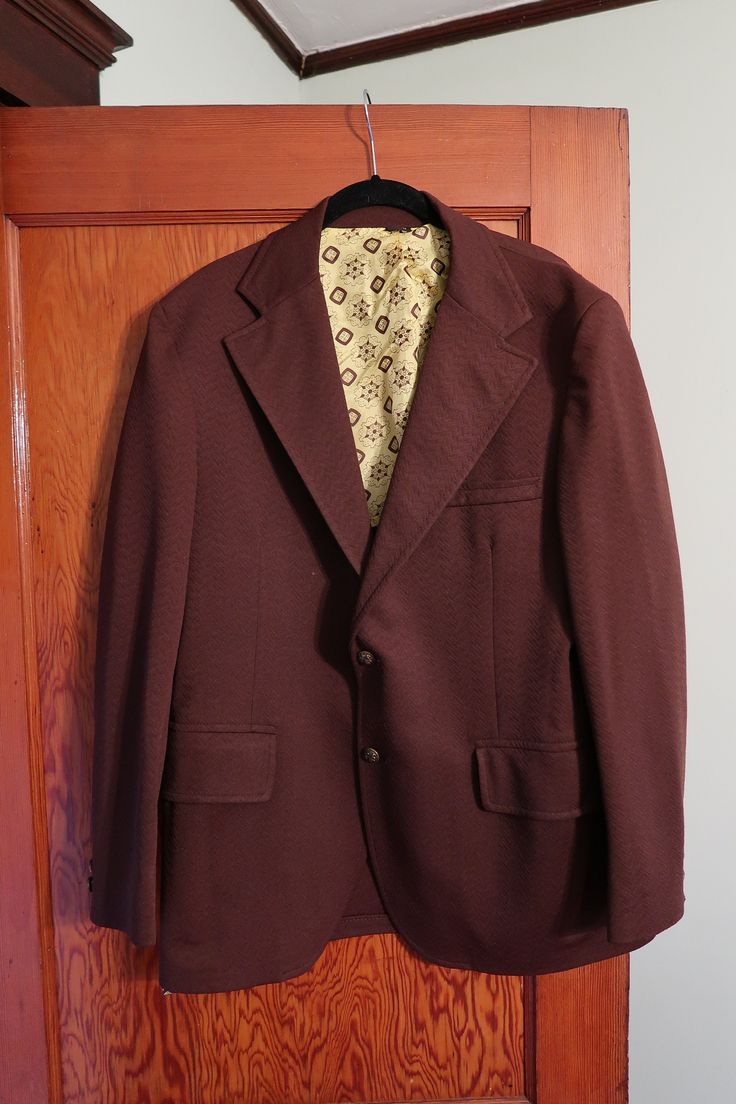 "This retro Dobbshire men's blazer is in gorgeous condition--it comes in a rich chocolate brown color, has a funky yellow lining, and has a crisp 70s collar.  Chest: 42\" Sleeve: 24\" Length: 29\"" Formal Single Button Brown Blazer, Brown Notch Lapel Sport Coat For Semi-formal Occasions, Tailored Brown Sport Coat With Pressed Crease, Brown Blazer With Single Button And Lapel Collar, Fall Brown Sport Coat With Pressed Crease, Brown Blazer With Welt Pockets And Flat Front, Brown Single Button Sport Coat With Suit Collar, Brown Single Button Sport Coat For Semi-formal Occasions, Brown Notch Lapel Sport Coat With Single Button