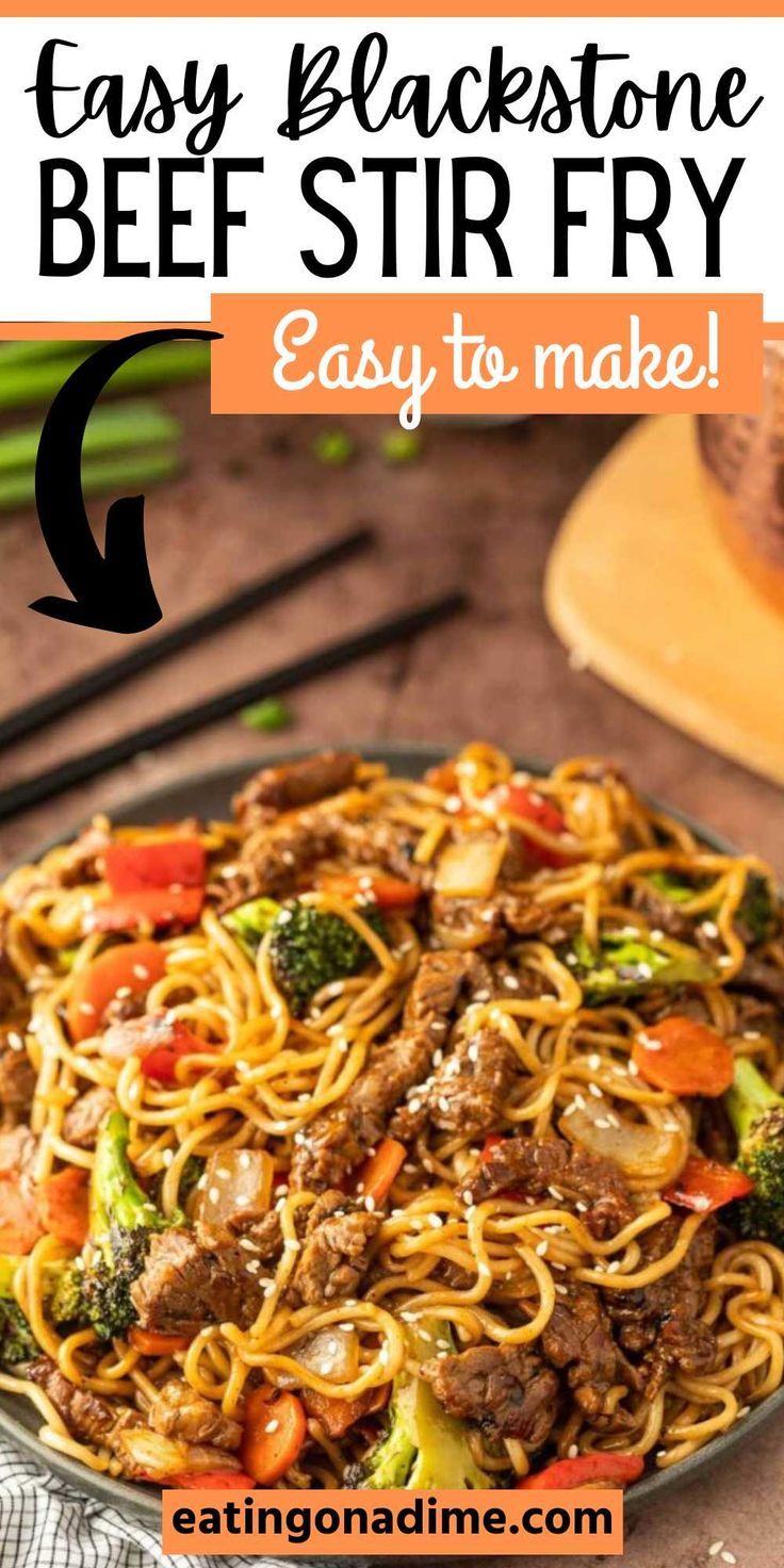 beef stir fry with noodles and broccoli in a skillet on a wooden table