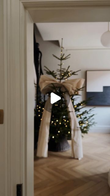 a living room filled with furniture and a christmas tree