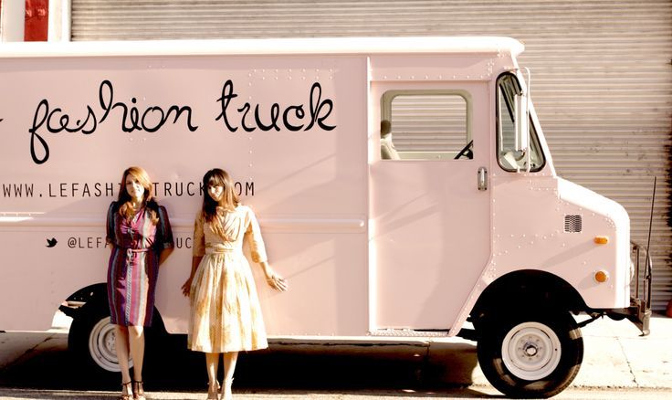 two women standing in front of a food truck with the words fashion tackle written on it