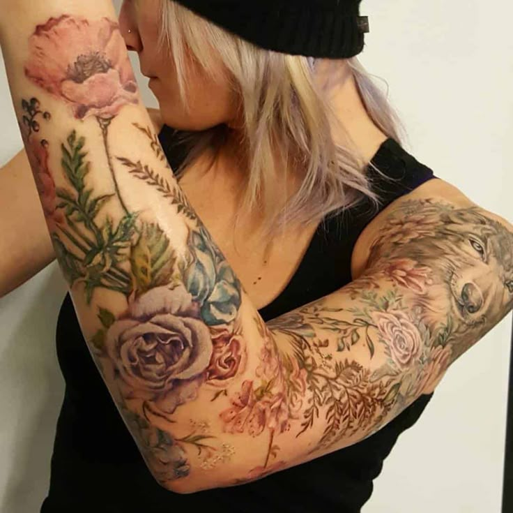 a woman with tattoos on her arms and arm