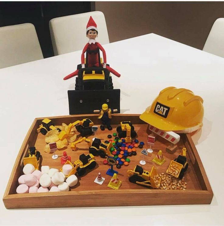 an elf is sitting on top of a construction themed tray