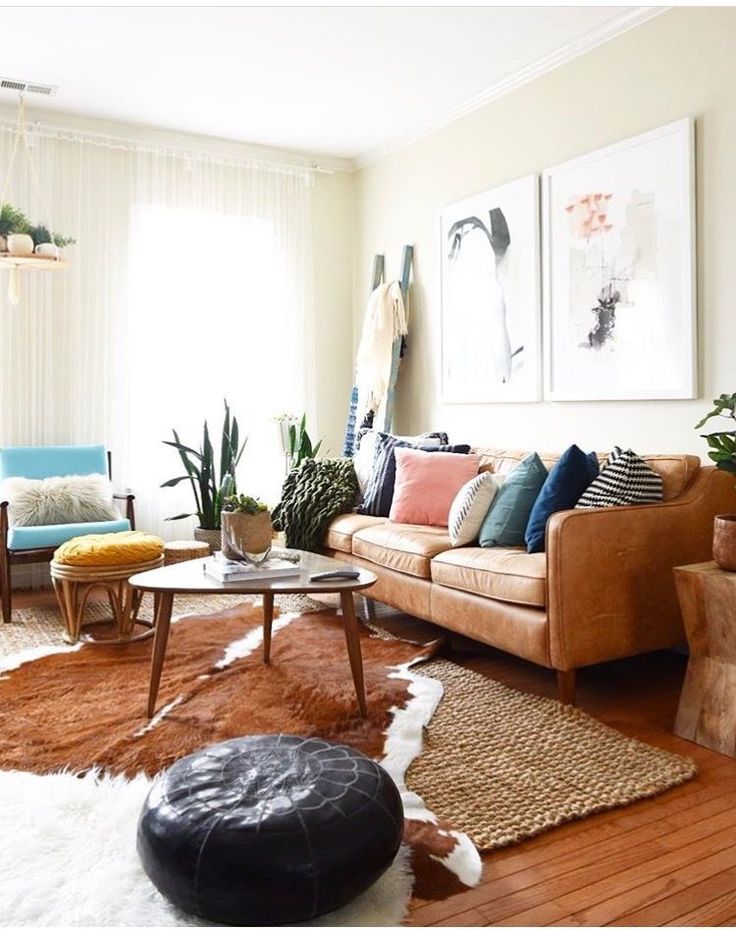 an image of a living room setting with couches and rugs on the floor