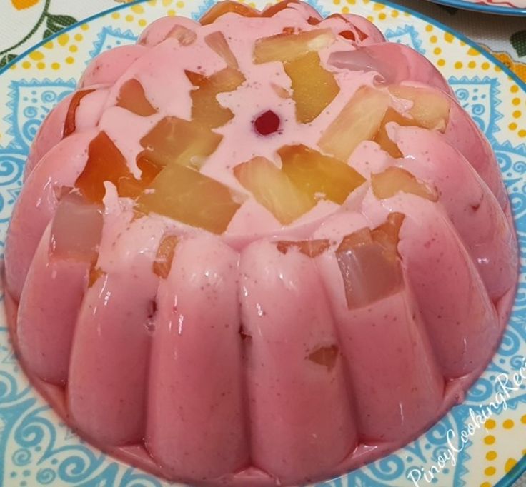 there is a pink cake with pineapple topping on the plate