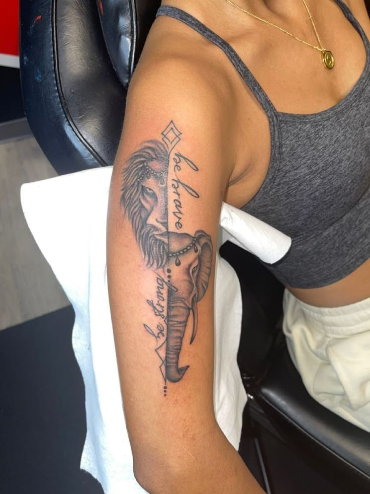 a woman sitting in a chair with a tattoo on her arm and an elephant head