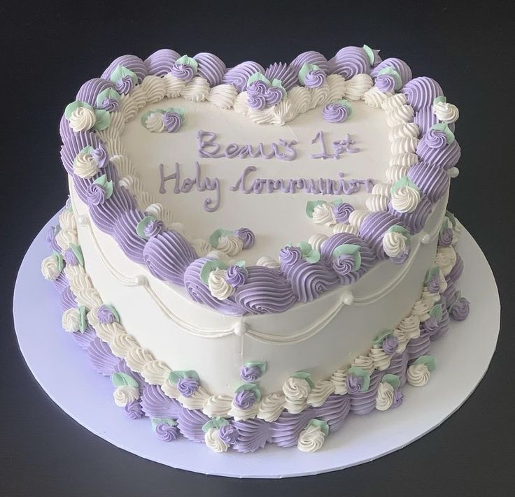 a heart shaped cake with purple and white frosting