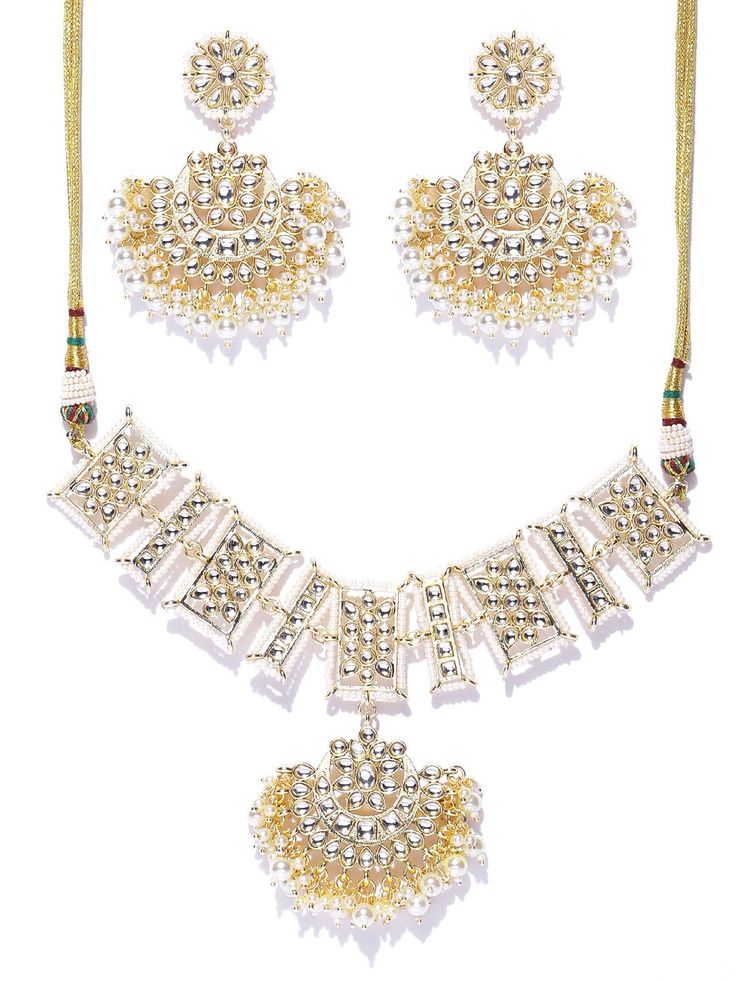 This impressive jewelry set consists of a drop necklace and a pair of chandbali earrings. The crescent-shaped beaded necklace shown in off-white color comes gold-plated with kundan stone studs, and secured with an adjustable drawstring closure. A pair of matching chandbali earrings come secured with a post and back closure. This eye-catching set can add impact to any outfit for any festive occasion! Get ready for compliments! Product color may vary based on the monitor or screen you are using.Se White Kundan Necklace With Gold Beads, White Necklace With Mirror Work For Festivals, White Mirror Work Jewelry For Eid, White Chandbali Jewelry With Mirror Work, Gold Necklace With Mirror Work, White Necklace With Mirror Work For Festive Season, White Jewelry Sets With Mirror Work For Festivals, White Jewelry Sets With Mirror Work For Celebration, White Chandbali Jewelry Sets For Eid