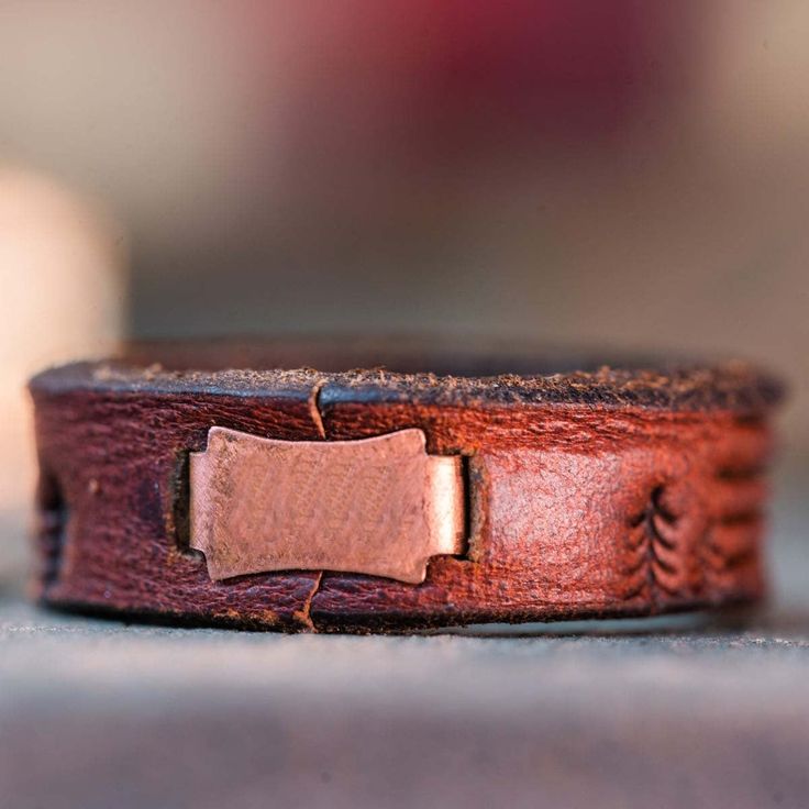 a close up of a brown leather bracelet