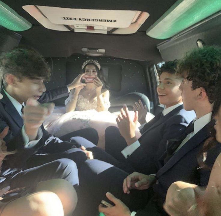 a group of people sitting in the back of a car