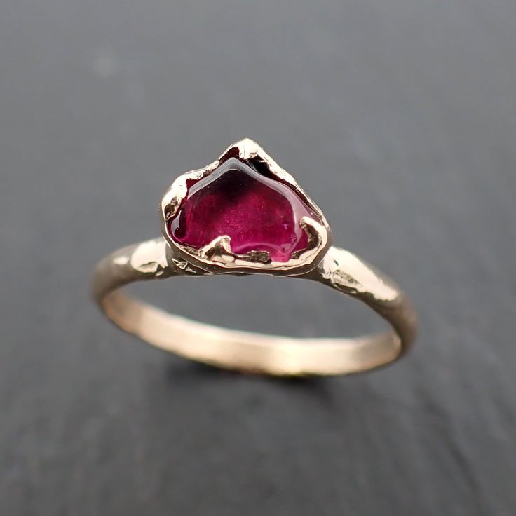 red Garnet (home tumbled). I hand carved this setting in wax and cast it in recycled solid 14k Yellow gold using the lost wax casting process. This one-of-a-kind gemstone ring is a size 7 it can be resized up or down for you as needed. The stone measures about 8.5x5.5mm. Throughout all time and history in every tribe and culture all around the world crystals, minerals and gemstones have been used for healing, luck, divination, adornment vibrational medicine and so much more. Garnet is the births