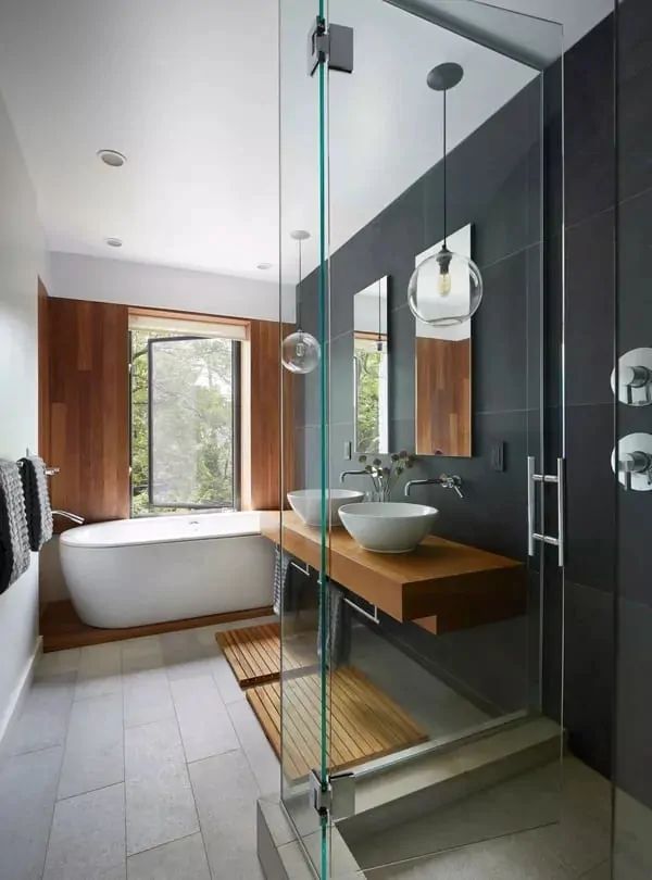 a bath room with a sink and a bath tub next to a window in it