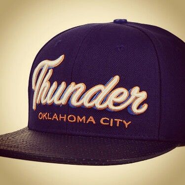 the thunder baseball cap is purple and has an orange word on it that says, thunder