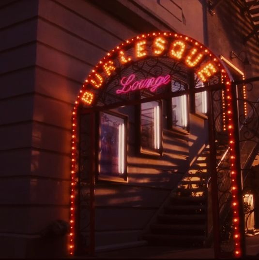 an entrance to a building with lights on it