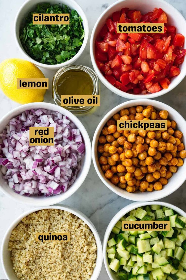 bowls filled with different types of food and labeled in the words lemons, olives, chickpeas, cucumber, red onions