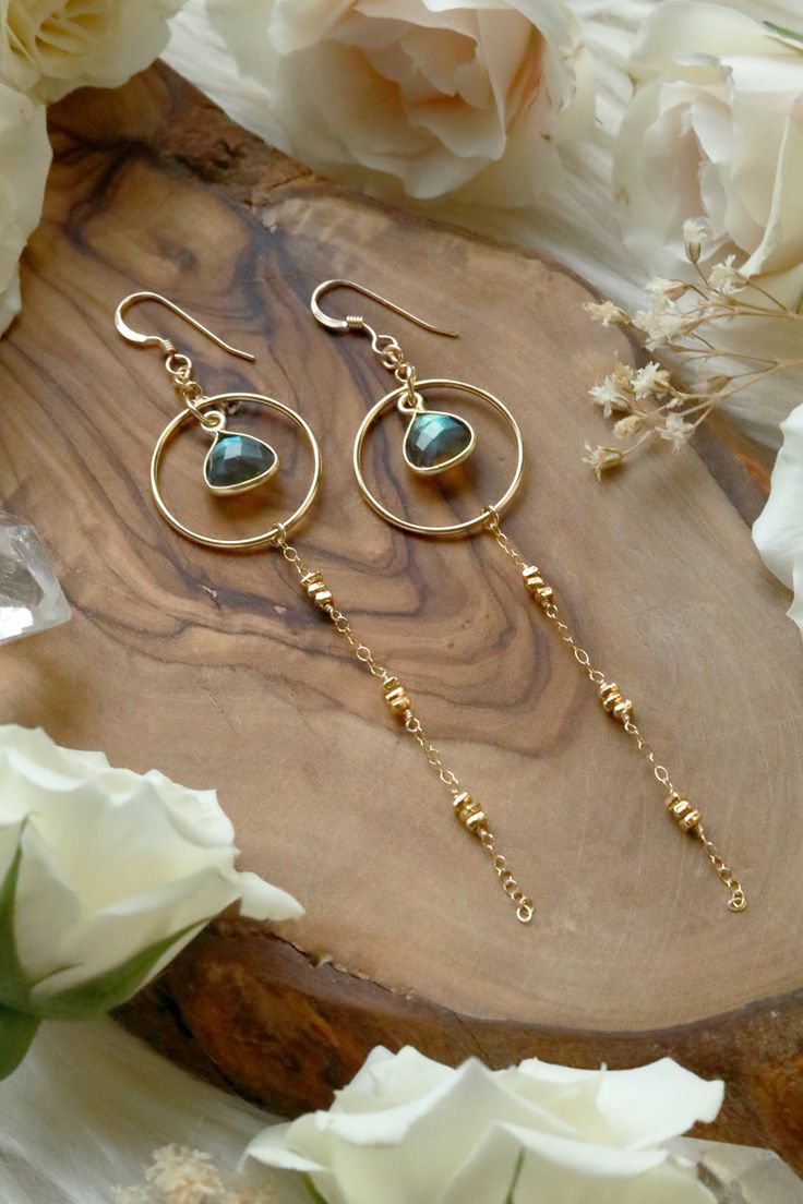 Our new Starlight Labradorite Gold Earrings are our next anticipated bestsellers with stunning flashy Labradorite gems cascading from golden hoops, chain, and beads. A sweet connection to the cosmos the Starlight Earrings represent inner knowing, infinite potential and endless dreams. Starlight Labradorite Gold Earrings are handcrafted with 14k Goldfilled + Gold Vermeil components, chain, and beads. 14k Gold Vermeil flashy Labradorite bezel. 14k Goldfilled Ear Wire. Hangs 3.625 inches long from top of ear wire. _____________________________ LabradoriteLabradorite, in striking hues ranging from deep blue and gray to iridescent flecks of green and gold, is thought by ancient cultures to have descended from the Aurora Borealis. Labradorite is both mystical and otherworldly, imbued with esoter Inner Knowing, Bezel Jewelry, Golden Hoops, Handmade Jewelry Tutorials, Wire Work Jewelry, Earrings Inspiration, Work Jewelry, Handmade Wire Jewelry, Funky Jewelry