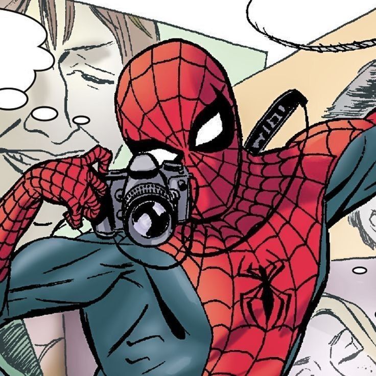 a man in a spider - man suit taking a selfie with a digital camera