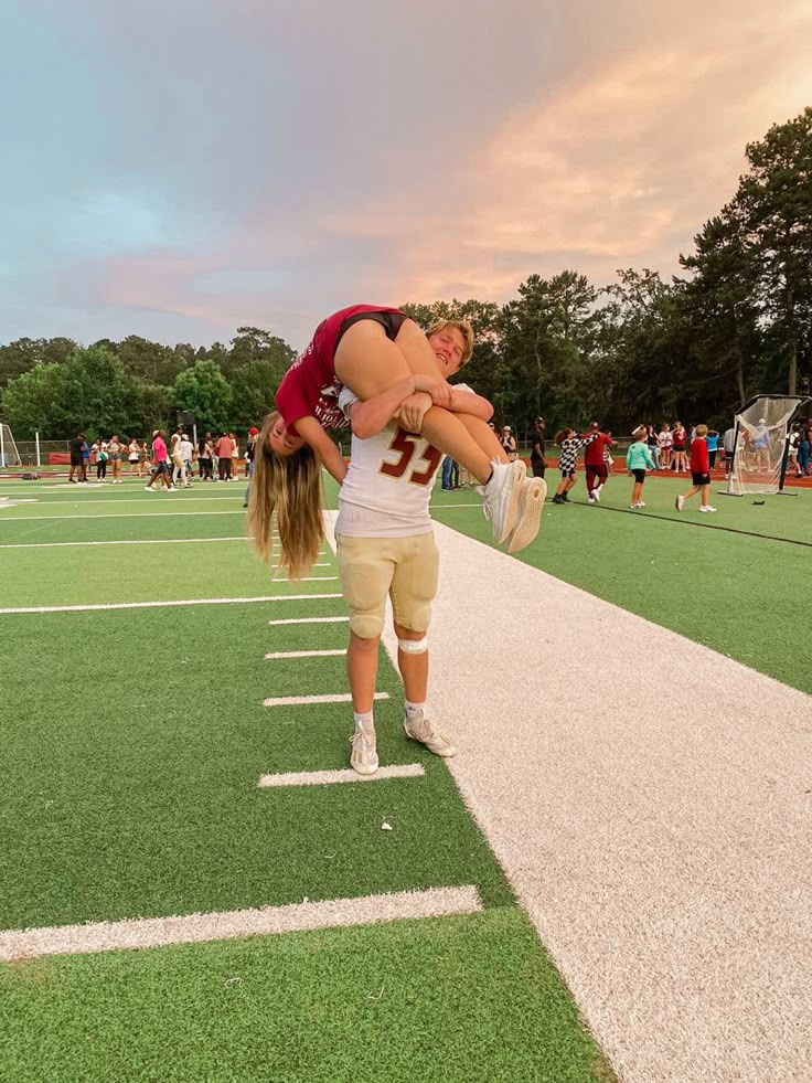 two football players are hugging each other on the field