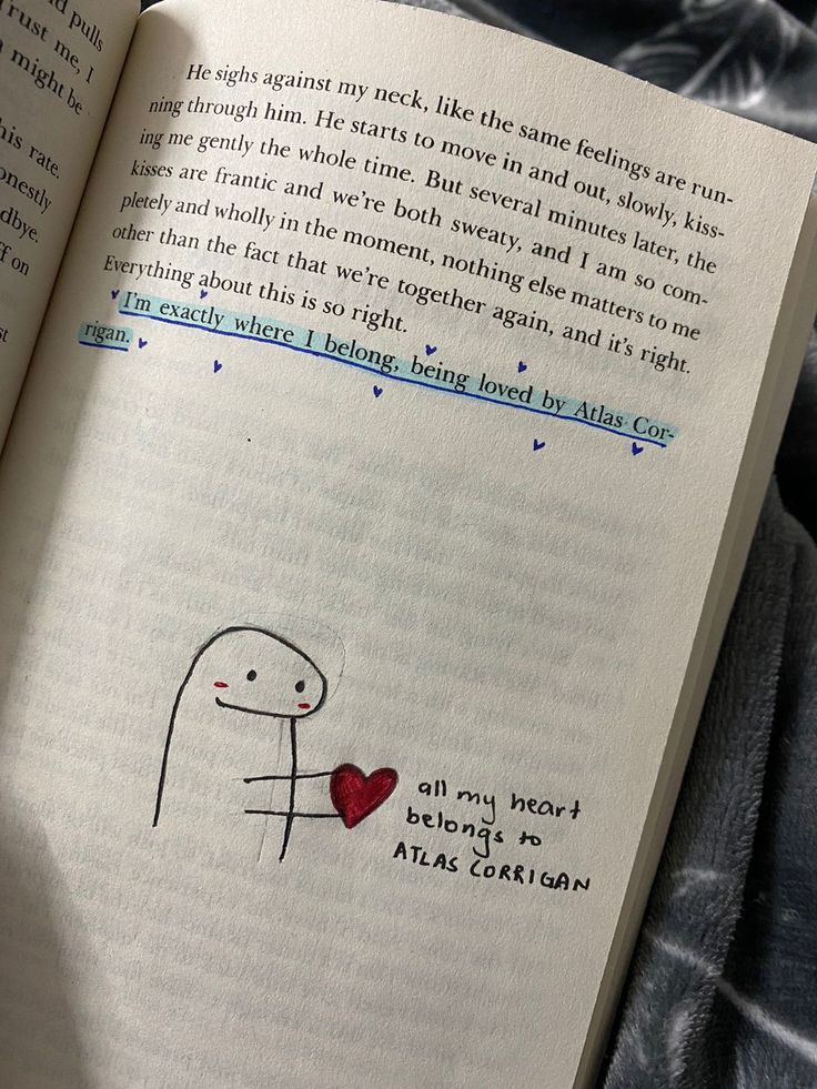 an open book with a drawing of a person holding a heart