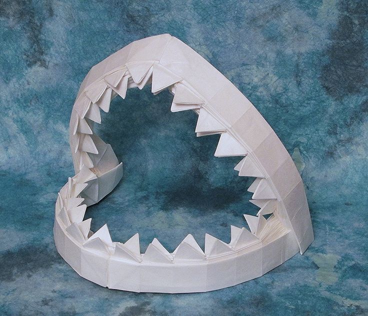 a paper model of a shark's teeth on a blue background