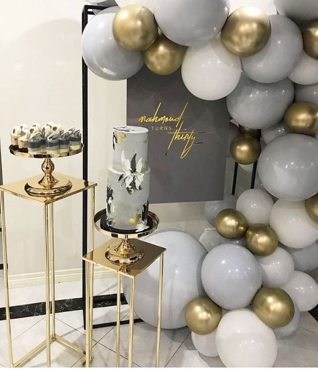 some white and gold balloons are on display