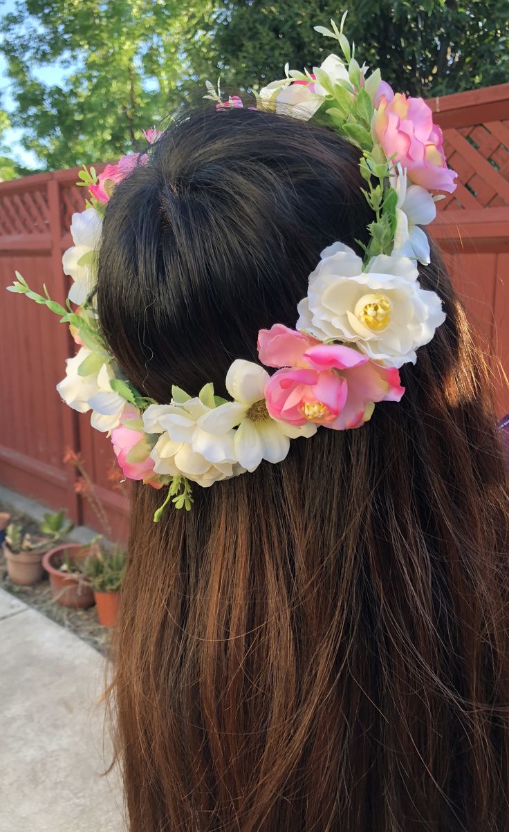 a woman with long hair wearing a flower crown