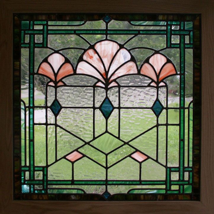 a stained glass window with green grass in the background