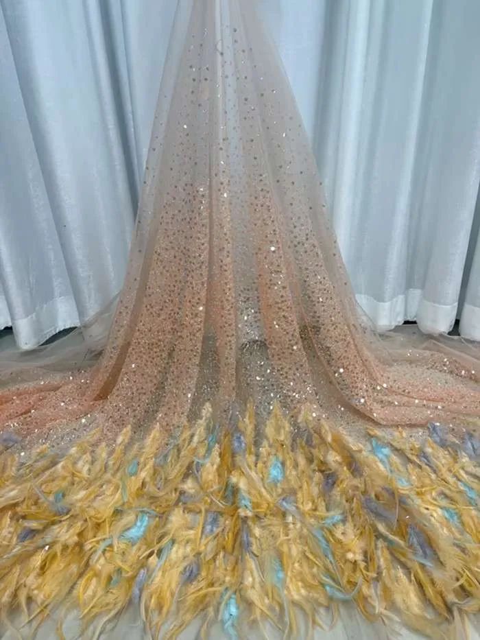 a wedding dress with feathers on the floor in front of a white curtain and curtains behind it