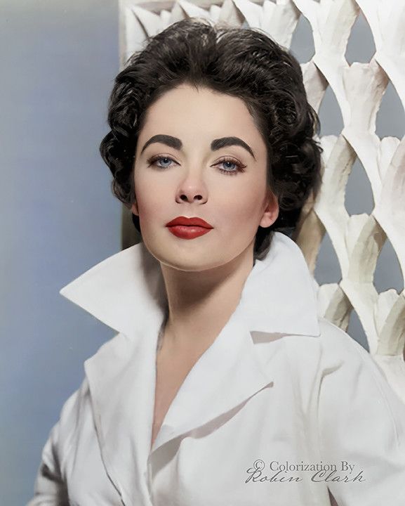 a woman with black hair wearing a white shirt and red lipstick is posing for the camera