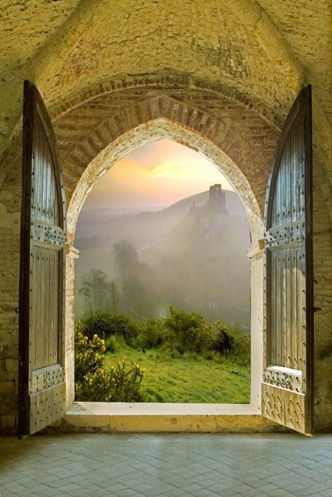 an open door with the words in french above it and a view of a field