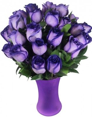 a purple vase filled with lots of purple flowers