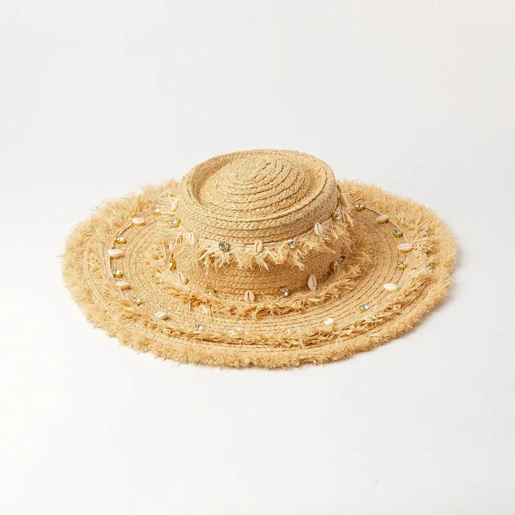 Embrace the sun while keeping cool and stylish with our Chic Raffia Sun Hat. Handcrafted from high-quality raffia, this hat is a must-have accessory for any beach goer or outdoor enthusiast looking to combine fashion with functionality. The elegant shell decoration adds a touch of seaside charm, making it a standout addition to your summer wardrobe. Key Features Sun Protection: Enjoy your day in the sun without the worry, as our hat offers excellent protection against harmful UV rays. Material: Made from 100% natural raffia, known for its durability and breathability. Design: Features a solid pattern with a casual style that complements any outfit. Seasonality: Perfect for spring and summer, providing both comfort and style in warm weather. Product Benefits Versatile Fashion: Its neutral c Beachwear Straw Sun Hat For Warm Weather, Beige Sun Straw Hat For The Beach, Straw Sun Hat For Sunbathing, Beachy Straw Boater Hat For Vacation, Summer Sun Straw Hat For Beach, Coastal Sun Hat For Beach, Sun Panama Hat For Beach Vacation, Summer Sun Straw Hat Made From Palm Leaf, Summer Vacation Straw Hat In Paper Straw