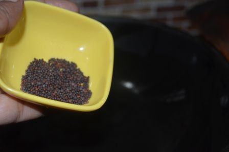 a person holding a yellow bowl filled with seeds