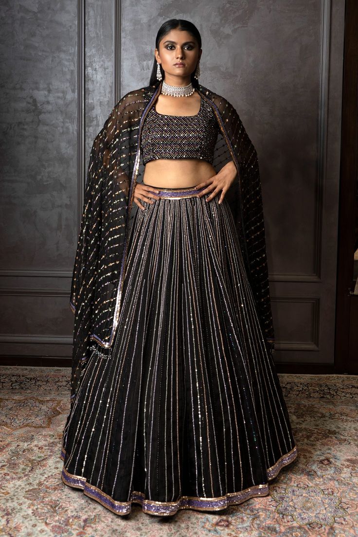 Black lehenga with multi color embroidery in sequins, pearls and cutdana. Comes with blouse and dupatta.
Component: 3
Pattern: Embroidered
Type Of Work: Sequins, Pearls, Cutdana
Neckline: Square
Sleeve Type: Sleeveless
Fabric: Organza, Raw Silk
Color: Black
Other Details: 
Back tassel tie-up blouse
Tassel hem dupatta
Occasion: Destination Wedding - Aza Fashions Square Neck Lehenga, Black Lehenga, Color Embroidery, Raw Silk, Black Sequins, Set For Women, Aza Fashion, Sleeve Type, Square Neck