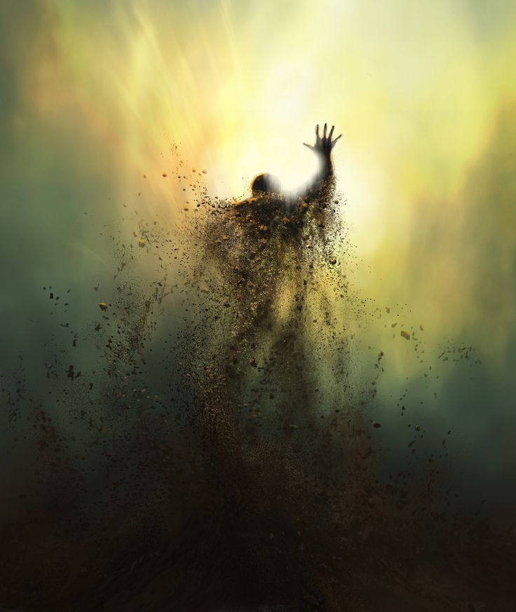 a person reaching up into the air with their hands in the air and dust flying around